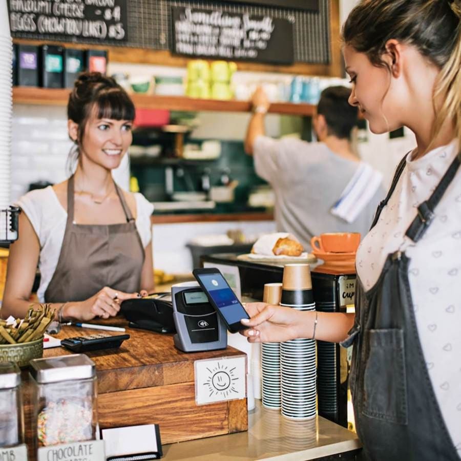 woman paying at a coffee shop