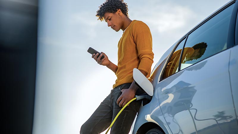 man leaning on car